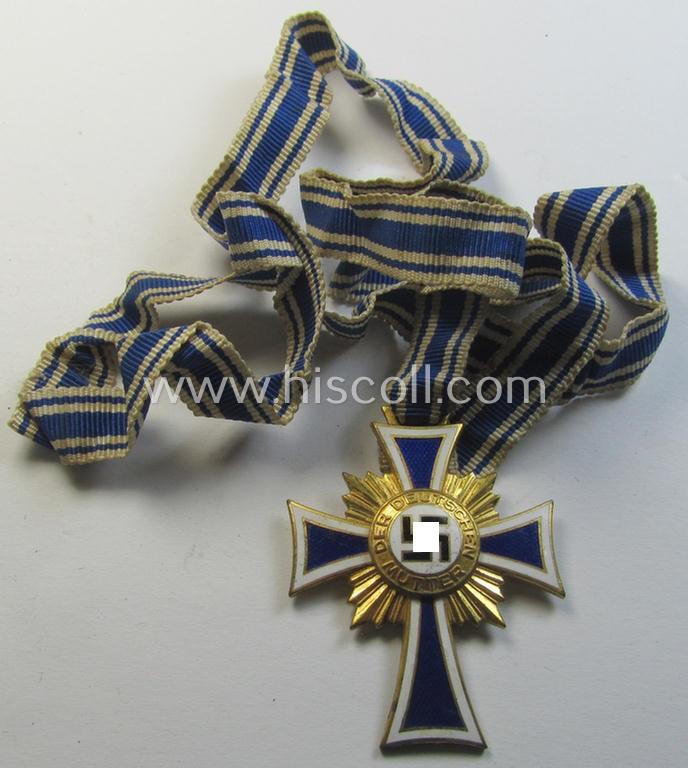 Attractive, 'Ehrenkreuz der deutschen Mutter - erste Stufe' (or: golden-class mothers'-cross) being a hardly used  example that comes mounted onto its accompanying, long-sized ribbon as issued and/or recently found