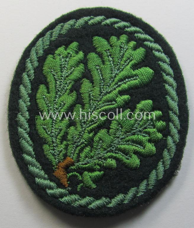 Attractive example of a WH (Heeres) so-called: 'Jäger'-armbadge being a neatly machine-embroidered- and/or multi-coloured version as was executed on darker-green-coloured wool