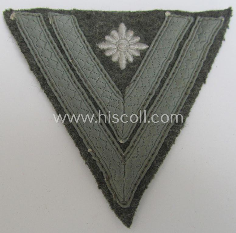 WH (Heeres) 'Armwinkel' (or: arm-chevron) as executed on typical field-grey-coloured wool as was specifically intended for usage by a soldier with the (unusually seen!) rank of: 'Stabsgefreiter'