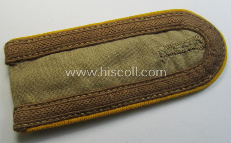 Single, WH (Luftwaffe) tropical-issued, NCO-type-shoulderstrap as executed in beige-coloured linnen (as was specifically intended for usage on the tropical-shirts ie. tunics) as was intended for an: 'Uffz. der Flieger- o. Fallschirmjäger-Truppen'