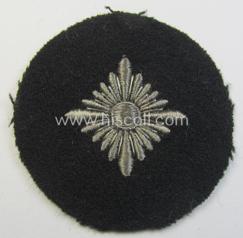 Waffen-SS- (ie. Heeres-'Panzer'-) type, machine-embroidered rank-badge (or: roundel) as was executed on smooth-type- and black-coloured wool as was intended for an: 'SS-Oberschütze' (ie. Heeres 'Oberschütze')