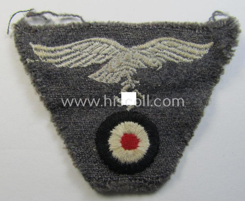 Attractive - and scarcely encountered! - WH (Luftwaffe) so-called: 'M43-pattern'-cap-trapezoid (being a machine-embroidered and carefully cap-removed example that is executed on a bluish-grey-coloured- and/or woolen-based background)