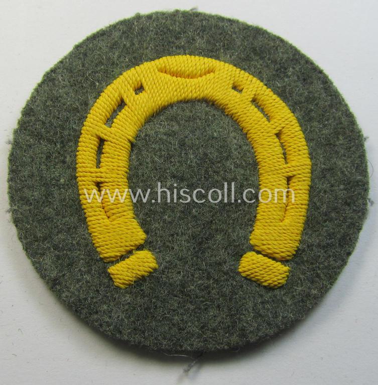 WH (Heeres) so-called trade- and/or special-career arm-patch as specifically intended for a: 'Hufbeschlagmeister' (or: farrier) being a neatly hand-embroidered 'variant' as executed on field-grey-coloured wool