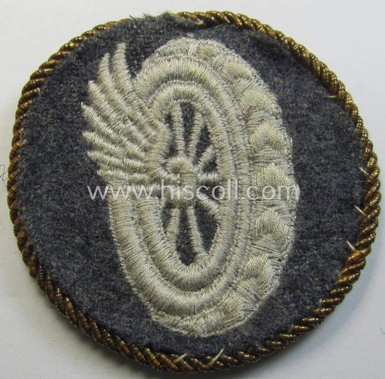 Attractive - albeit clearly used! - example of a WH (Luftwaffe) machine-embroidered, trade- ie. special-career-patch (ie. 'Tätigkeitsabzeichen') having a golden-coloured 'Goldkordel' attached as was intended for a: 'Schirrmeister o. Geräteverwalter'