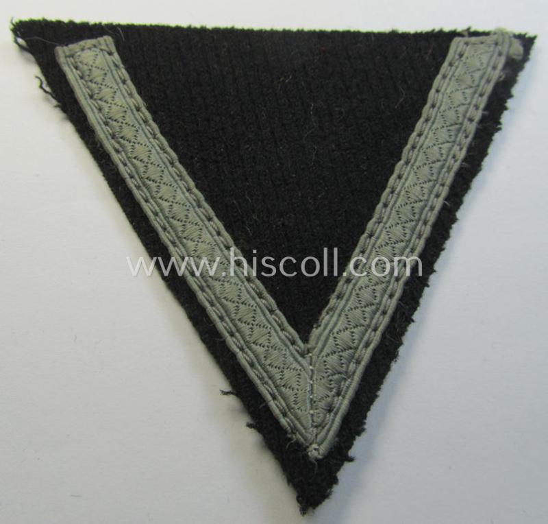 Attractive - and clearly used! - Waffen-SS- (ie. Heeres Panzer-) type 'Armwinkel' (or: rank-chevron) as executed on black-coloured wool as was intended for an: 'SS-Mann' (ie. 'Gefreiter')