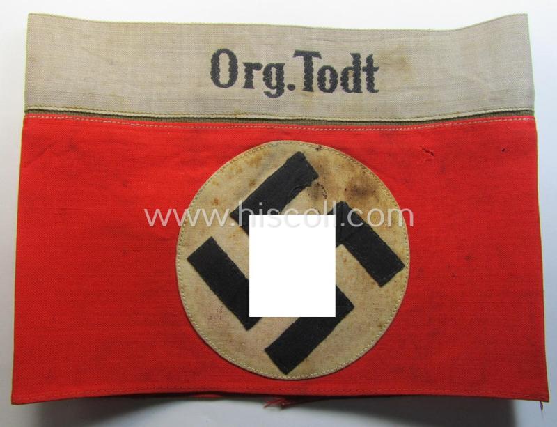 Attractive - and rarely found! - OT (ie.: 'Organisation Todt') EM- (ie. NCO-) pattern cuff-title (ie. 'Ärmelband für Mannschaften u. Uffz.') combining a swastika- and 'Org.Todt'-cuff-title and being a moderately used- ie. tunic-removed example