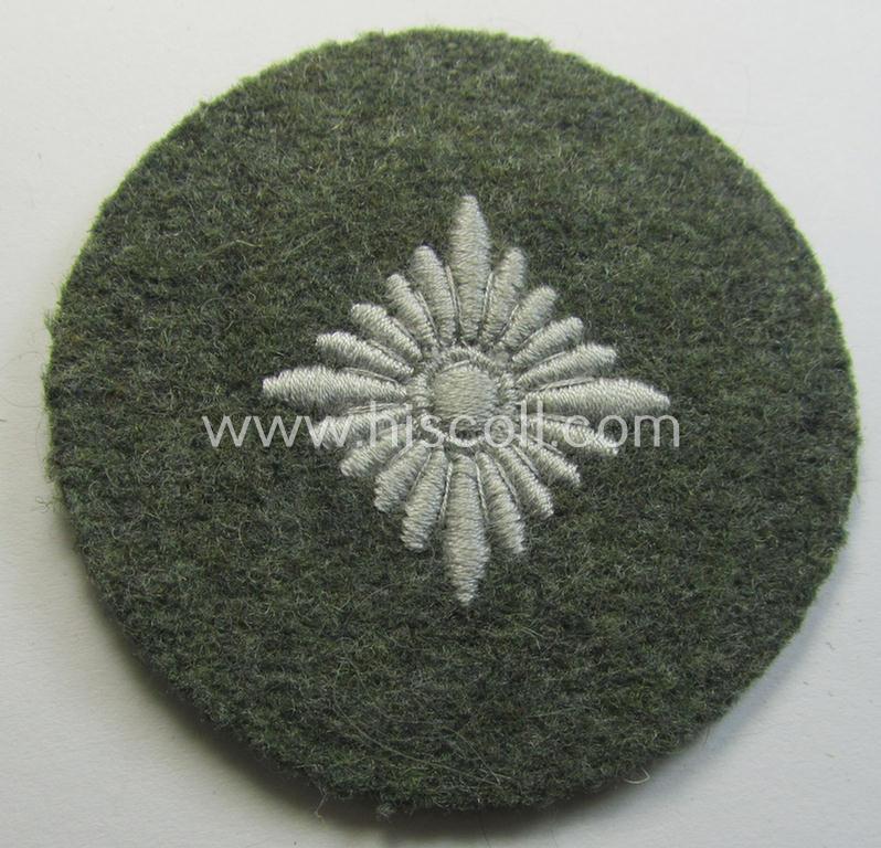 WH (Heeres) rank-insignia (ie. silver-grey-coloured and machine-embroidered 'roundel') as intended to identify a soldier with the rank of: 'Oberschütze', 'Oberjäger' etc. that comes in a 'virtually mint- ie. unissued', condition