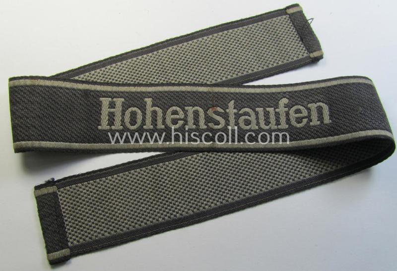 Superb, 1943/44-pattern 'BeVo'-woven Waffen-SS cuff-title, depicting the machine-woven 'Latin'-script text in silver-grey linnen as was intended for a member of the: '9. SS-Panzer-Division' “Hohenstaufen”