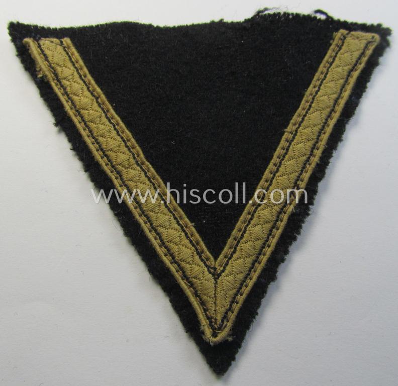 Truly used, Waffen-SS-type 'Armwinkel' (or: rank-chevron) as executed on black-coloured wool as was specifically intended for usage by an SS-soldier with the rank of: 'SS-Sturmmann'