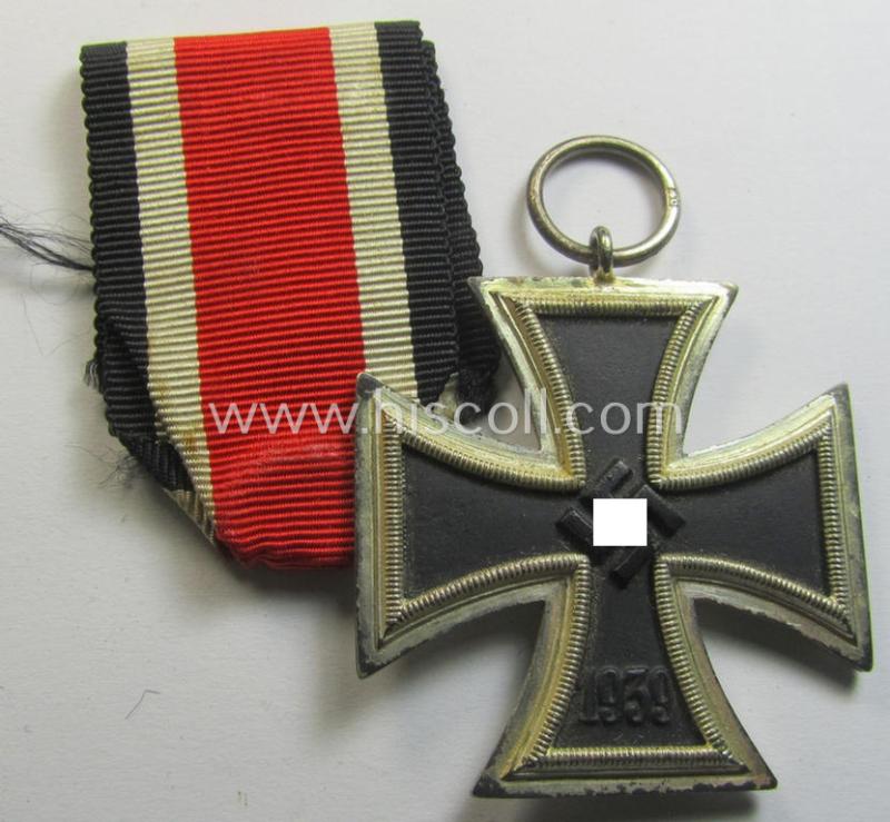 'Eisernes Kreuz II. Klasse' being a maker- (ie. '40'-) marked example that comes together with its original- and clearly once-mounted ribbon (ie. 'Bandabschnitt') as was produced by the maker (ie. 'Hersteller'): 'Berg & Nolte'