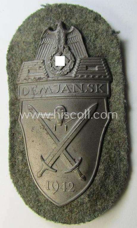 Superb example of a - fairly scarcely encountered! - WH (Heeres ie. Waffen-SS) 'Demjansk'-campaign-shield as executed in typical magnetic metal (ie. so-called: 'Eisenblech') and that comes in an overall very nice- ie. fully untouched, condition