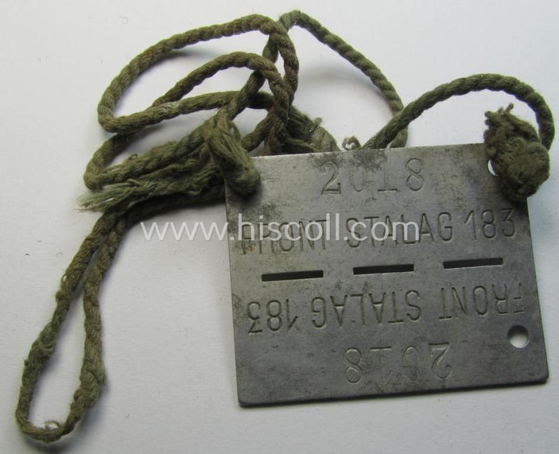 Attractive, zinc-based WH (Heeres) 'Frontstalag'- (ie. prisoner-related-) ID-disc bearing the clearly stamped camp-designation that reads: 'Frontstalag 183' and that comes still mounted onto its (period-attached) cord as issued- and/or worn