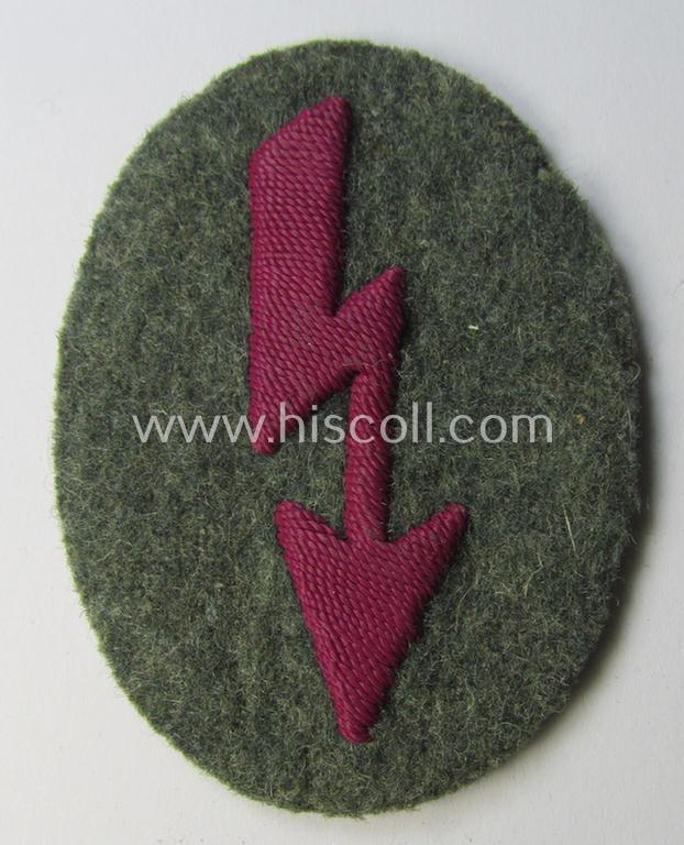 Neat, WH (Heeres) trade- and/or special-career-insignia (ie. hand-embroidered 'signal-blitz') being a clearly maker-marked example as executed in bordeaux-coloured linnen as was specifically intended for a soldier within the: '(Nebel)Werfer-Truppen'