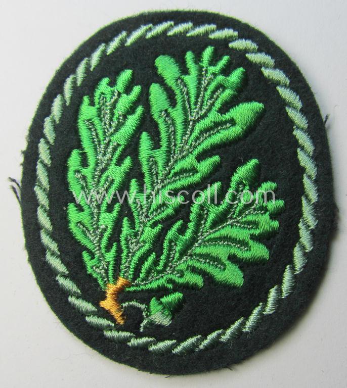 Attractive example of a WH (Heeres) so-called: 'Jäger'-armbadge being a neatly machine-embroidered- and/or multi-coloured version as was executed on darker-green-coloured wool