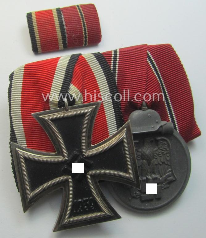Attractive, two-pieced medal-bar-set (ie. 'Ordenspange u. Feld-/Bandspange-Satz') showing resp. an: 'Eisernes Kreuz II. Kl.' and a: 'Medaille Winterschlacht im Osten 1941-42' that both come period-mounted as a: 'Doppelspange'