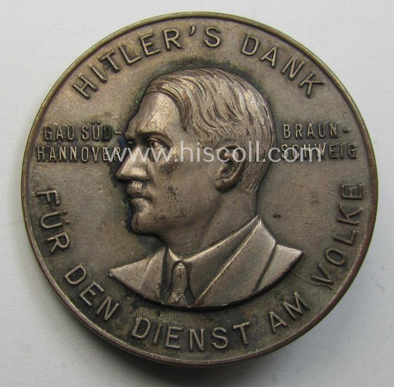 Commemorative, silvered 'Buntmetall'-based N.S.D.A.P.- (ie. WHW-) related 'tinnie' being a maker- (ie. 'Paulmann u. Crone'-) marked example depicting A. Hitler and text: 'Hitlers' Dank für den Dienst am Volke - Gau Süd-Hannover - Braunschweig'