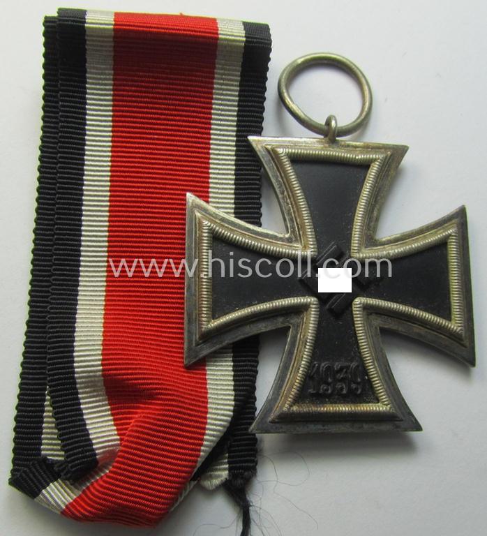 'Eisernes Kreuz II. Klasse' being a non-maker-marked example that comes together with its original- and once-mounted ribbon (ie. 'Bandabschnitt') as was produced by a (by me) unidentified maker (ie. 'Hersteller')