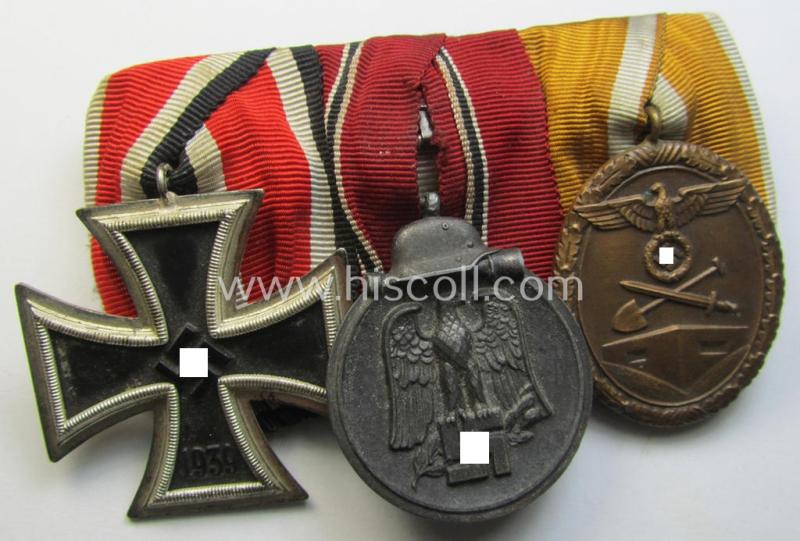 Superb, 3-pieced WWII-period medal-bar (ie. 'Ordenspange') showing respectively an: 'EKII. Kl.', a: 'Winterschlacht im Osten 1941/42'-medal (ie. 'Ost'-medal) and a: 'Deutsches Schutzwall Ehrenzeichen') ie. 'Westwall'-medal