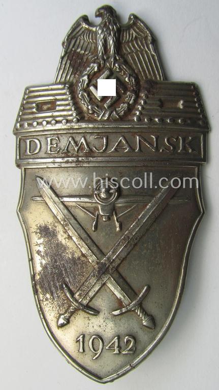 Attractive - truly used- and regrettably incomplete - example of a WH (Heeres ie. Waffen-SS) 'Demjansk'-campaign-shield as executed in typical magnetic, so-called: 'Eisenblech' (and being of the 'missing-log' variant-pattern)