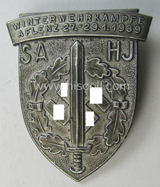 Commemorative, aluminium-based SA- o. HJ (ie. 'Sturmabteilungen'-) related 'tinnie' being a maker-marked example showing an 'SA-Sportabzeichen' and text: 'Winterwehrkämpfe - Aflenz - 27.-29.-1.1939'