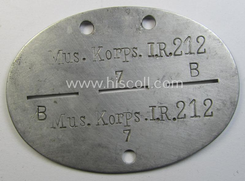 Superb - and very scarcely found! - typical aluminium-based, WH (Heeres-) ie. 'Infanterie u. Musiker'-related ID-disc (ie. 'Erkennungsmarke') bearing the clearly stamped unit-designation that reads: 'Mus.Korps.I.R.212' and that comes as issued