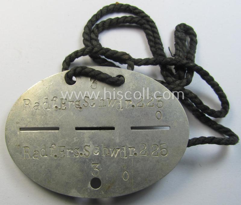 Superb - and scarcely found! - typical aluminium-based, WH (Heeres-) ie. 'Radfahr'-related ID-disc (ie. 'Erkennungsmarke') bearing the clearly stamped unit-designation that reads: 'Radf.Ers.Schwdr. 225' and that comes mounted onto its cord as issued