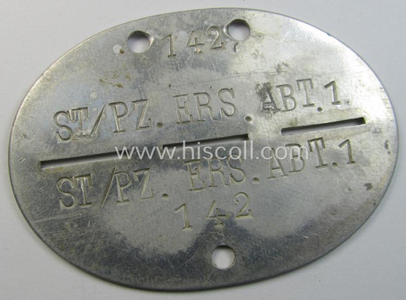 Superb - and scarcely found! - typical aluminium-based, WH (Heeres-) ie. 'Panzer'-related ID-disc (ie. 'Erkennungsmarke') bearing the clearly stamped unit-designation that reads: 'St/Pz.Ers.Abt.1' and that comes as issued and/or worn