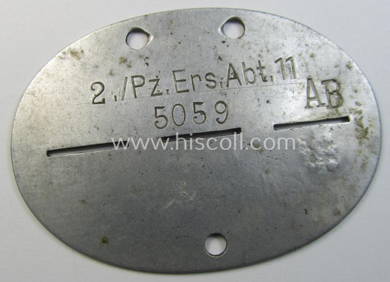 Superb - and scarcely found! - typical aluminium-based, WH (Heeres-) ie. 'Panzer'-related ID-disc (ie. 'Erkennungsmarke') bearing the clearly stamped unit-designation that reads: '2./Pz.Ers.Abt.11' and that comes as issued and/or worn