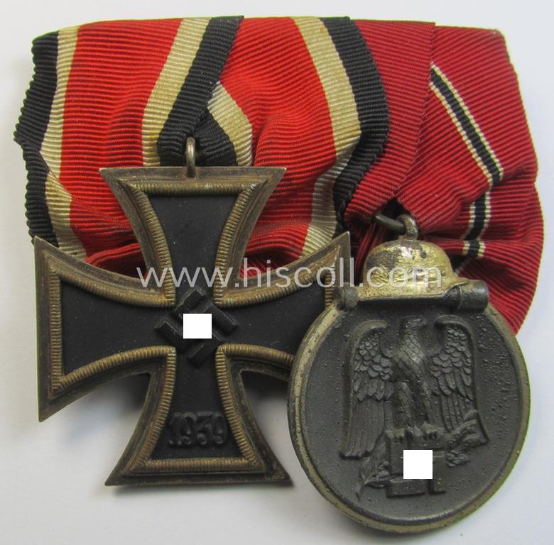 Attractive - and desirable! - two-pieced medal-bar (ie. 'Orden- o. Doppelspange') showing resp. an: 'Eisernes Kreuz II. Kl.' and a: 'Medaille Winterschlacht im Osten 1941-42' that both come period-mounted as a: 'Doppelspange'