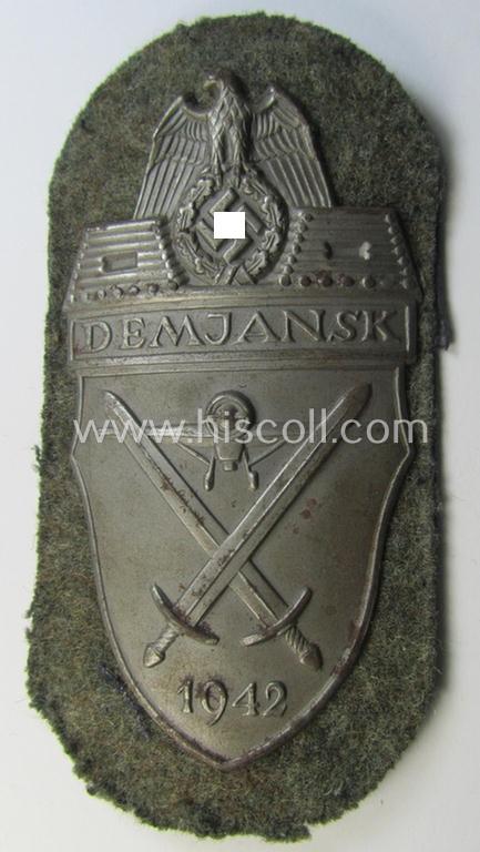 Superb example of a - fairly scarcely encountered! - WH (Heeres ie. Waffen-SS) 'Demjansk'-campaign-shield as executed in typical magnetic metal (ie. so-called: 'Eisenblech') and that comes in an overall very nice- ie. fully untouched, condition