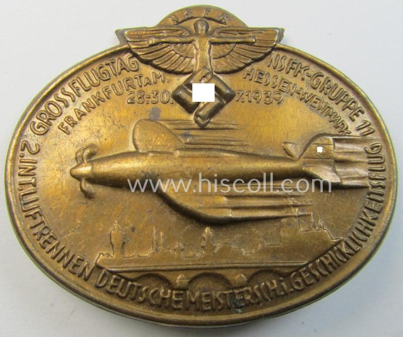 Commemorative, 'N.S.F.K.'-related 'tinnie' depicting the: 'N.S.F.K.'-logo and text: 'Grossflugtag - NSFK-Gruppe 11 - Frankfurt a. M. - Hessen Westmark - 28.30.7-1939' and sub-titled: '2. Int. Luftrennen D. Meister i. Geschicklichkeitsflug'