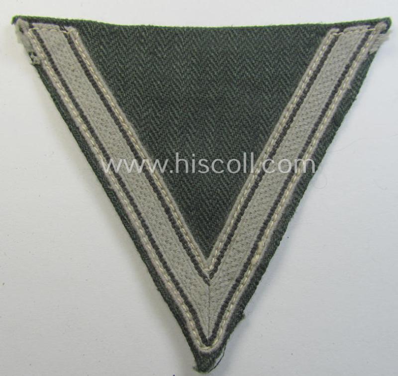 Attractive, WH (Heeres ie. Waffen-SS) 'Armwinkel' (or: arm-chevron) as was executed on a greenish-coloured- and/or 'HBT'-like (ie. 'Drillich'-) based background as was specifically intended for an: 'Gefreiter' (ie. 'SS-Mann')