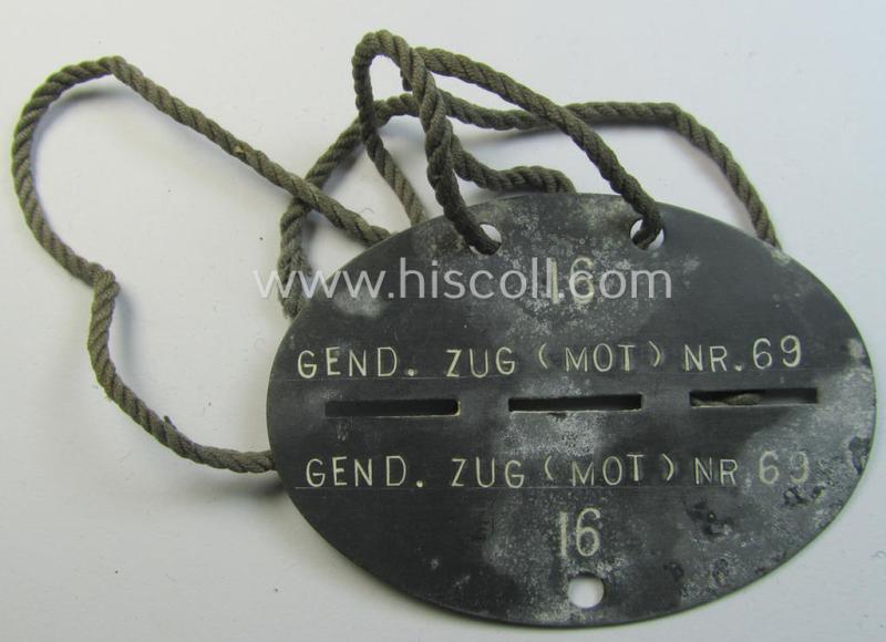 Attractive - and scarcely found! - typical zinc-based, 'Polizei o. Gendarmerie'-related ID-disc (ie. 'Erkennungsmarke') bearing the clearly stamped unit-designation that reads: 'Gend.Zug(mot) nr. 69' and that comes mounted onto its period-cord