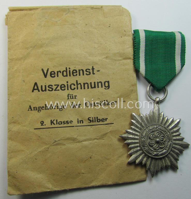 Superb, WH-related: 'Verdienstsauszeichnung für Angehörige der Ostvölker, 2. Kl. in Silber ohne Schwertern' being a maker- (ie. '100'-) marked example that comes stored in its period 'Zellstoff'-based pouch