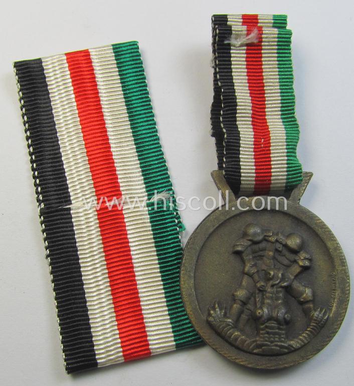 Attractive, golden-bronze-coloured- (and I deem 'Feinzink'-based-) example of a: 'Deutsch-Italienische Feldzugsmedaille' (or: German-Italian campaign medal) that came together with its (regular-sized) piece of original ribbon