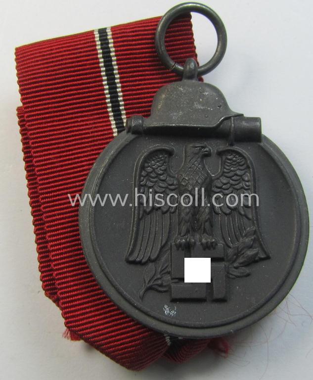 Neat medal-set: 'Winterschlacht im Osten 1941-42' being a non-maker-marked- (and/or typical 'Feinzink'-based) specimen that comes together with its (minimally confectioned) ribbon (ie. 'Bandabschnitt')