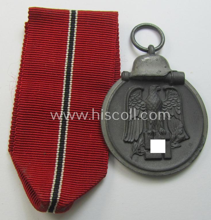 Neat medal-set: 'Winterschlacht im Osten 1941-42' being a non-maker-marked- (and/or typical 'Feinzink'-based) specimen that comes together with its (minimally confectioned) ribbon (ie. 'Bandabschnitt')