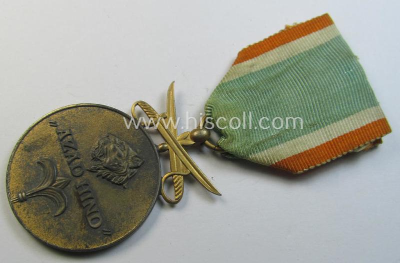 Attractive, WH-related so-called: 'Azad Hind - Goldene Tapferkeits-Medaille mit Schwerten' (being a typical non-maker-marked- and/or: 'Feinzink'-based example that comes mounted onto its period ribbon)