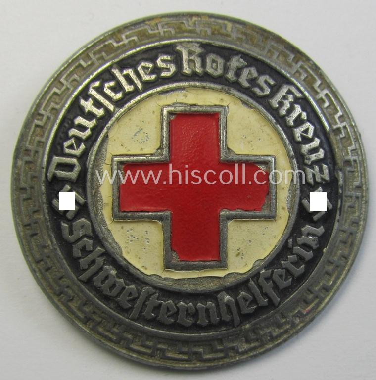 Attractive - and nicely preserved! - 'Feinzink'-based, DRK (ie. 'Deutsches Rotes Kreuz' or German Red Cross) nurses'-helpers-badge entitled: 'Schwesternhelferin' (being an example that shows a: 'Ges.Gesch.'- and/or: 'GB'-designation