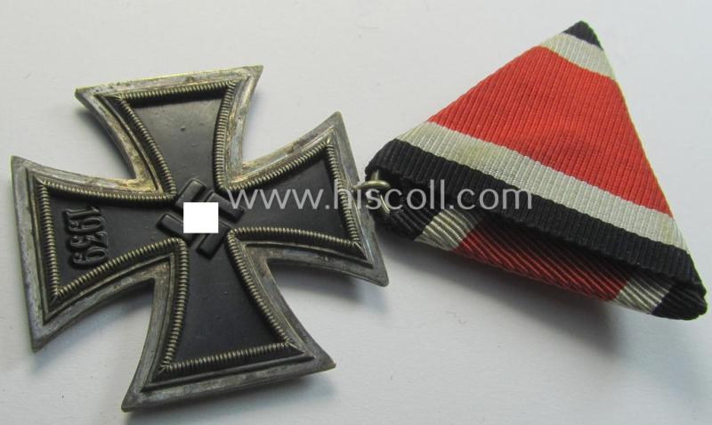 Neat, Iron Cross 2nd class (or: 'EK II. Klasse') being a non-maker-marked example that comes mounted onto its original (Austrian-styled!) ribbon (ie. 'Bandabschnitt') as was (I deem) produced by the (Austrian-based) company named: 'Rudolf Souval'