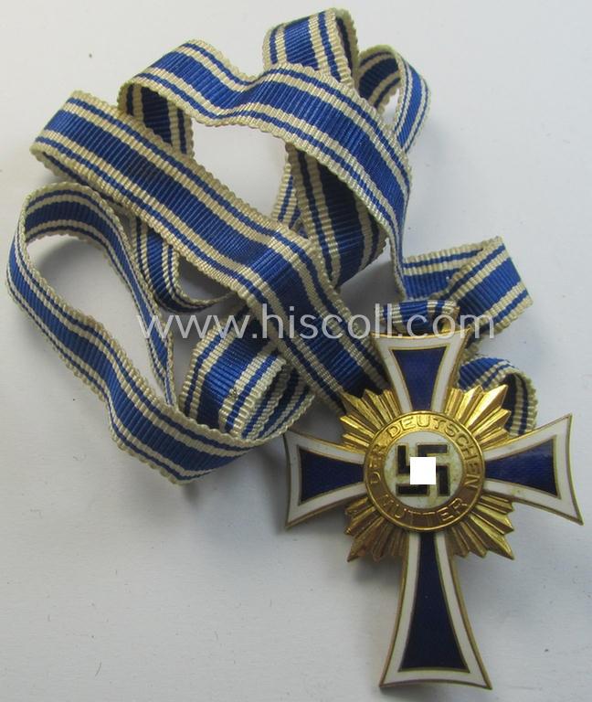 Attractive, 'Ehrenkreuz der deutschen Mutter - erste Stufe' (or: golden-class mothers'-cross) being a hardly used example that comes mounted onto its accompanying, long-sized ribbon as issued and/or recently found
