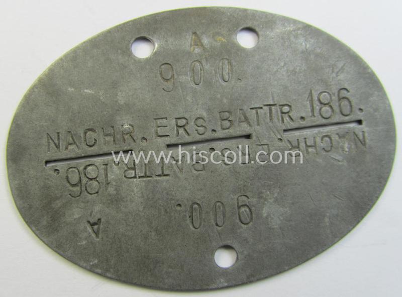 Attractive, zinc-based WH (Heeres) ie. 'Nachrichten'-related ID-disc (ie. 'Erkennungsmarke') bearing the clearly stamped unit-designation that reads: 'Nach.Ers.Battr. 186' and that comes as issued- and/or worn