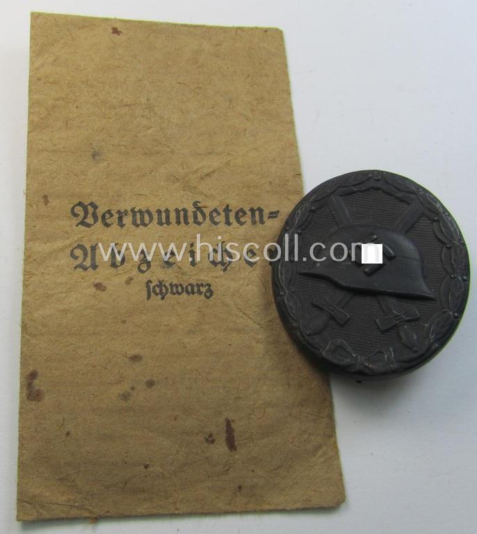 Superb 'Verwundeten-Abzeichen in Schwarz' (or: black-class wound-badge) being a maker- (ie. '81'-) marked example as was produced by the: 'Overhoff & Cie.'-company that comes together with its period (and fully complete) pouch as issued