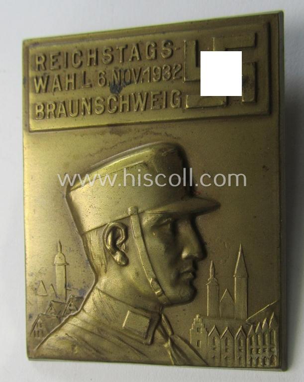 Commemorative, tin-based- and/or: golden-bronze-coloured (I deem) N.S.D.A.P.-related 'tinnie' depicting an SA-man, towns'-view and swastika-device and that is entitled: 'Reichstagswahl - 6.Nov. 1932 - Braunschweig'