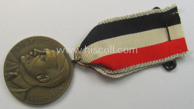 Attractive, bronze-toned commemorative-medal (ie. 'Erinnerungs-Medaille') entitled: 'Adolf Hitler - Unser Führer' and that comes mounted onto its period tri-coloured ribbon (ie. 'Bandabschnitt')