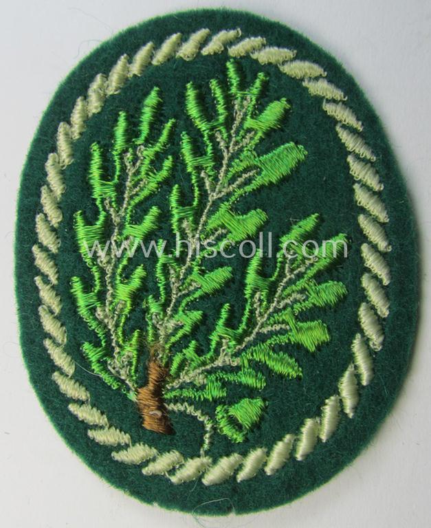 Attractive example of a WH (Heeres) so-called: 'Jäger'-armbadge being a neatly machine-embroidered- and/or multi-coloured version as was executed on darker-green-coloured wool