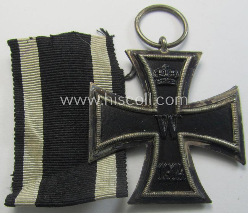 Attractive, WWI-period: 'Eisernes Kreuz II. Klasse' (or: iron cross second class) being a maker- (ie. 'KO'-) marked example that comes together with its (minimally) confectioned piece of ribbon (ie. 'Bandabschnitt')