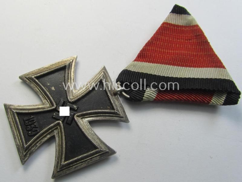 Neat, Iron Cross 2nd class (or: 'EK II. Klasse') being a non-maker-marked example that comes mounted onto its original (Austrian-styled!) ribbon (ie. 'Bandabschnitt') as was (I deem) produced by the (Austrian-based) company named: 'Rudolf Souval'