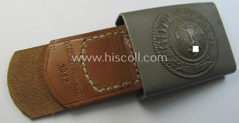 Stunning, WH (Heeres) 'standard-pattern', field-grey-toned- and aluminium-based belt-buckle being a maker- (ie. 'P&C'-) marked- example that comes mounted onto its (1942 !-dated) leather-based tab