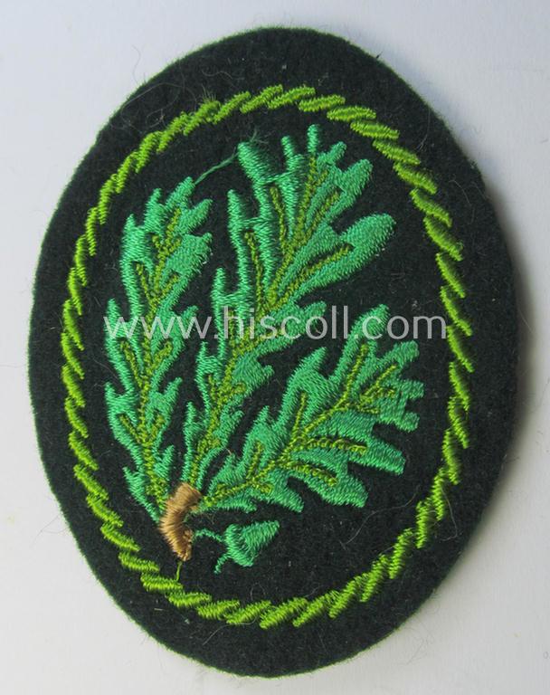 Attractive example of a WH (Heeres) so-called: 'Jäger'-armbadge being a neatly machine-embroidered- and/or multi-coloured version as was executed on darker-green-coloured wool